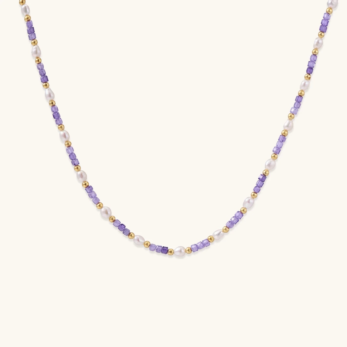 Delicate 18K gold vermeil necklace with alternating lavender zirconia beads and white freshwater pearls on cream background