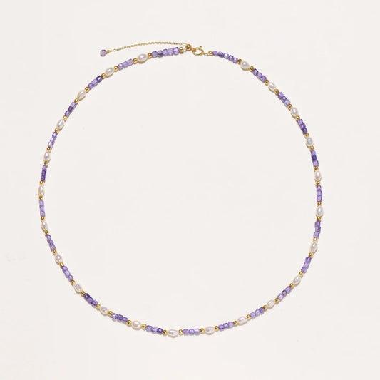 Delicate 18K gold vermeil necklace with alternating lavender zirconia beads and white freshwater pearls on cream background