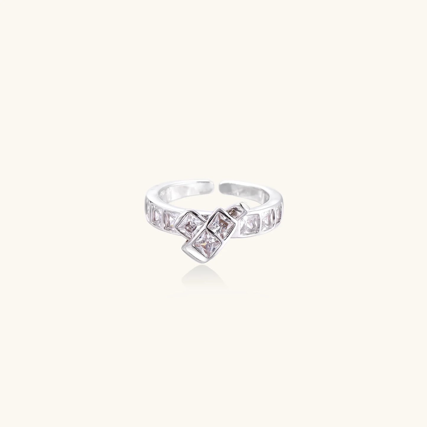White gold plated adjustable ring featuring offset square cubic zirconia stones in an architectural stacked design